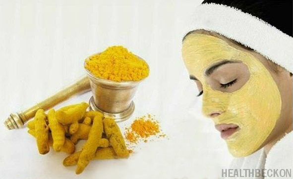 powdered tumeric in a bowl and a woman's face with beauty mask mixture using tumeric
