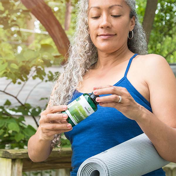 woman holding bottle of ashwagandha