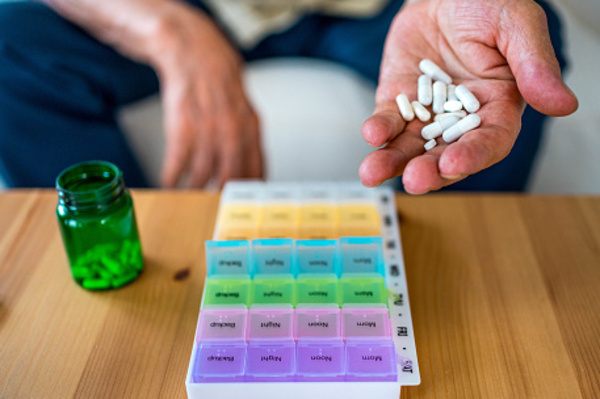 image of person putting pills in an organizer